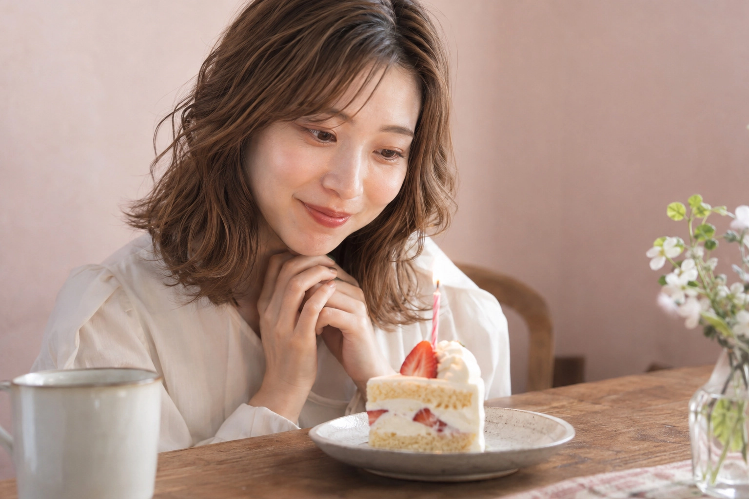 ひとりで誕生日のケーキを眺める女性
